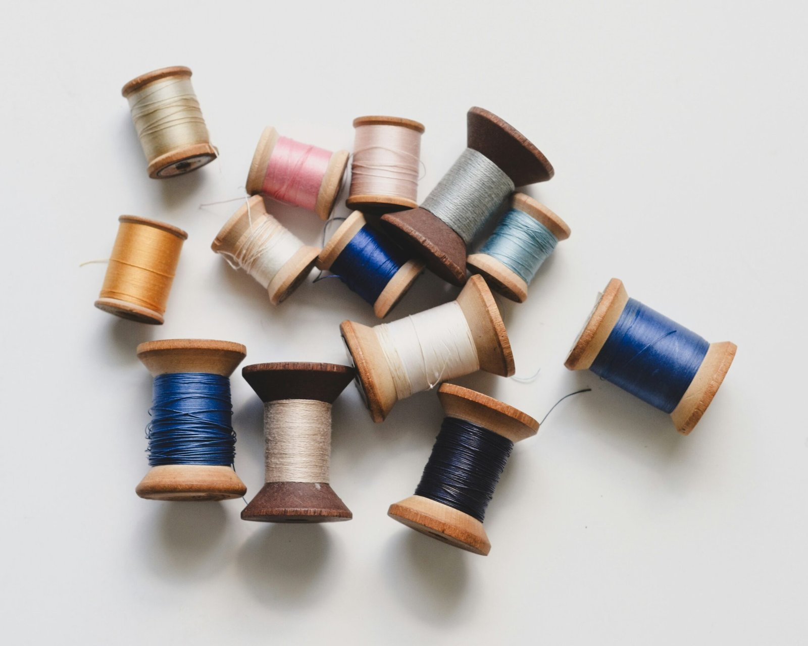 Handcrafted embroidery thread spools in various colors